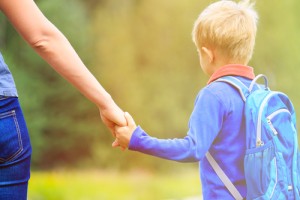 Mom holding sons hand